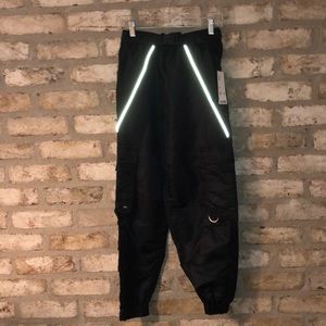 Black 100% Nylon jogger pants with a buckle belt